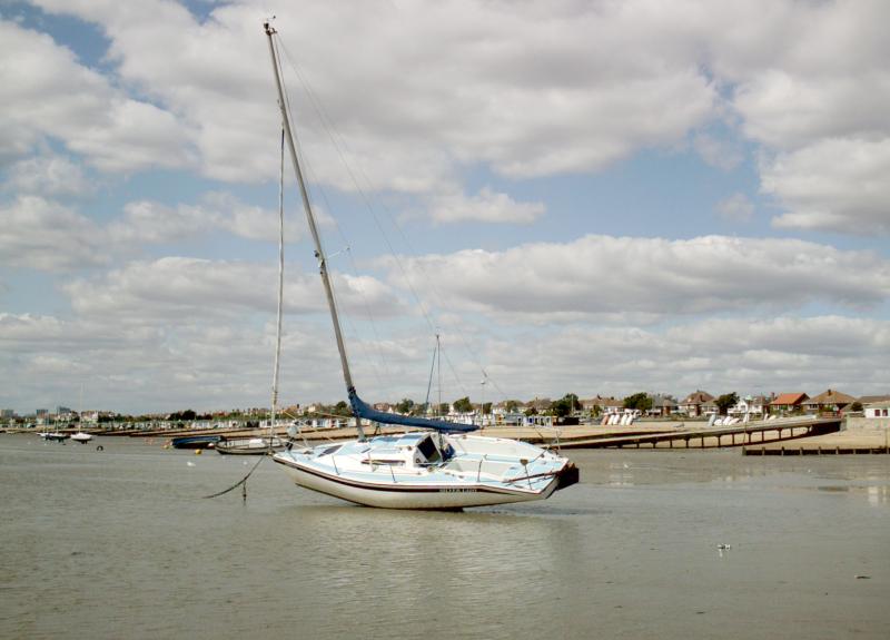 A yacht lying at anchor in very shallow water