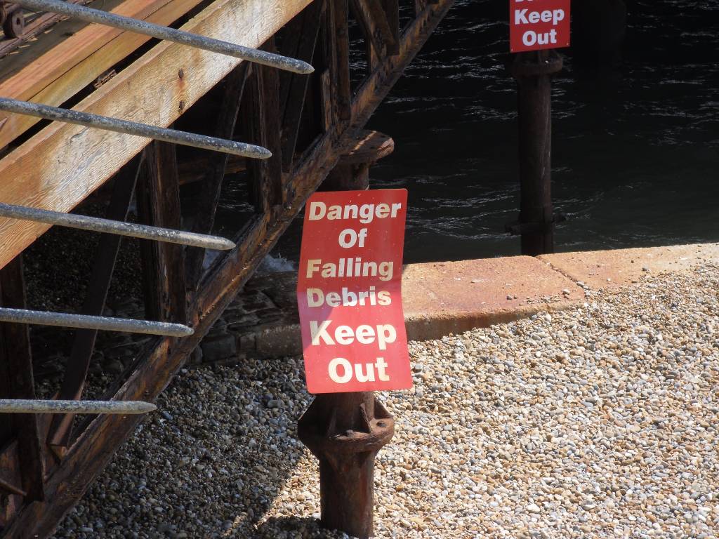 danger of falling debris sign on Hastings pier