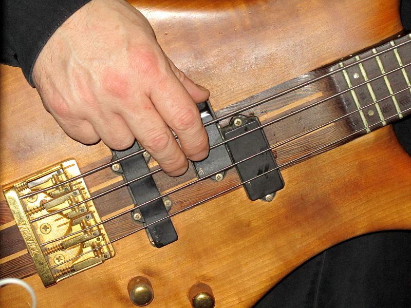close up of Steve Cox playing his Warwick Streamer bass guitar