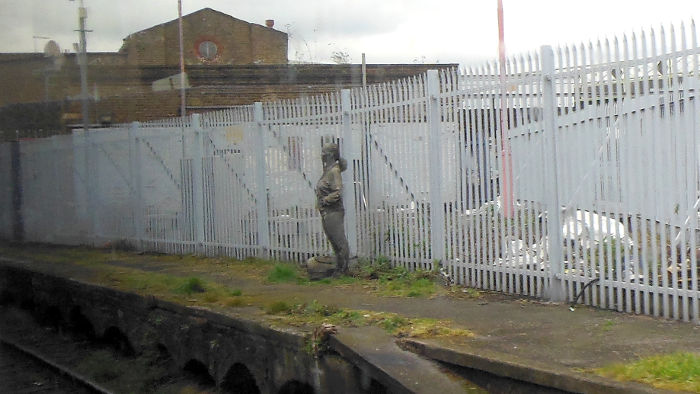 solitary bronze figure on the remains
                          of the disused platform