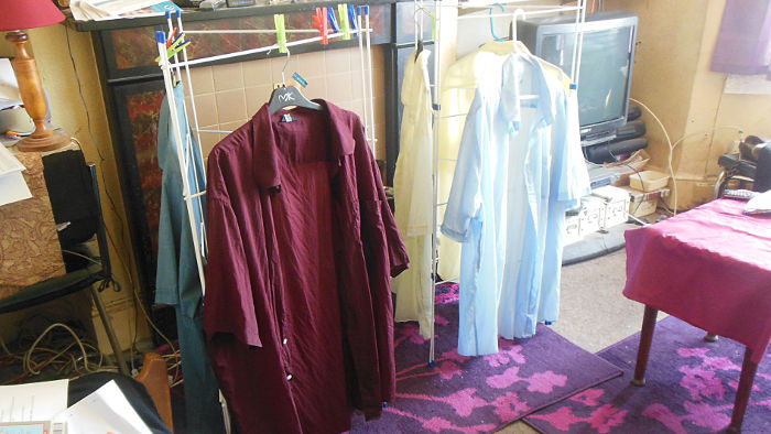 five shirts drying on hangers