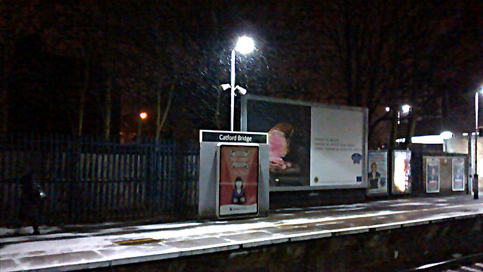 snow swirling past a platform light at
                          Catford Bridge station