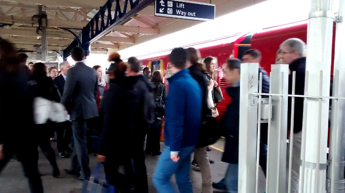 crowds stream
                          through the barriers that usually lock off
                          platform 1 at Earlsfield