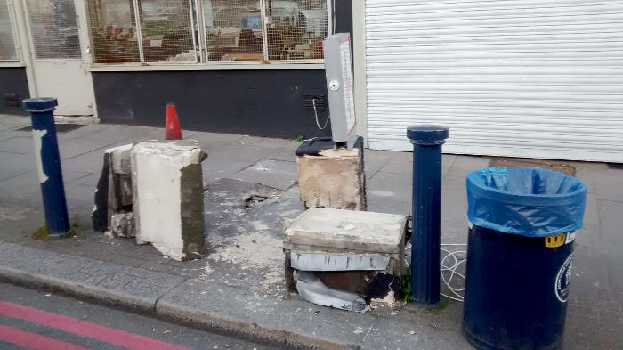 debris around a big
                          crater on the pavement