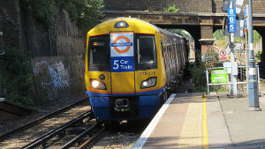 5
                                    car London Overground train pulling
                                    into Denmark Hill station
