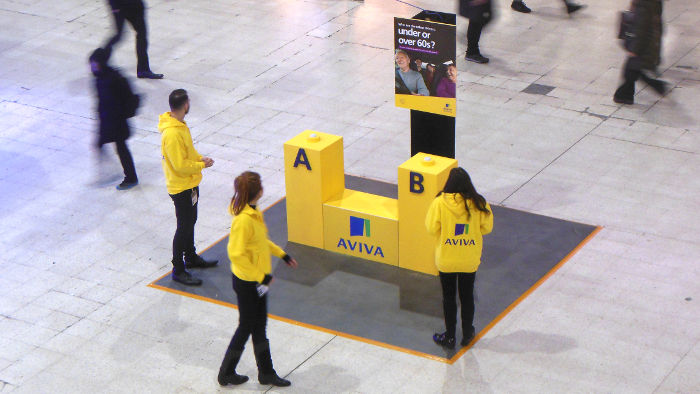 Aviva flogging their wares
                  on the concourse of Waterloo station