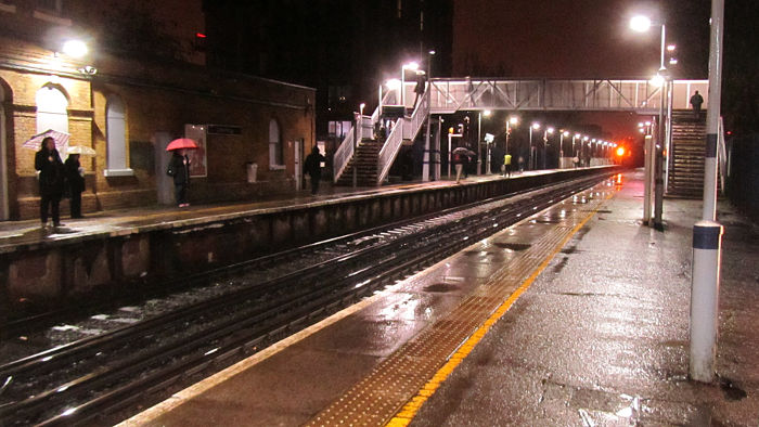 A wet and soggy platform 1 seen from near the
                  entrance on platform 2 of Catford Bridge