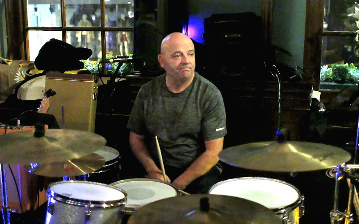 John Sutcliff the
                        drummer waiting for someone to tune up before
                        playing