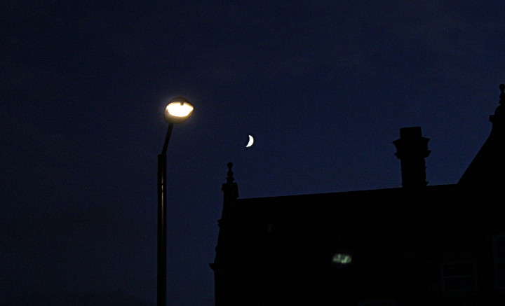 the moon near planet lamp post