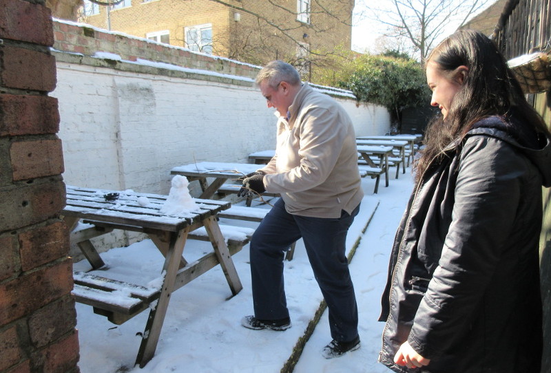 Building a small snowman in the garden of
                      the pub