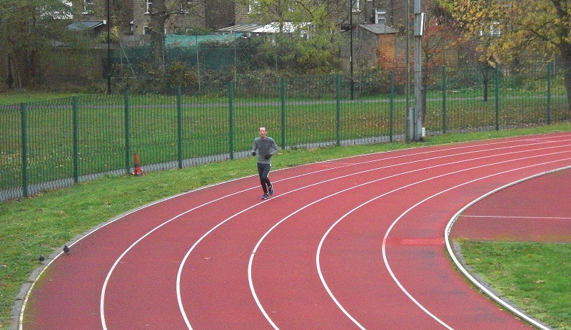solitary athlete on
                        the running track