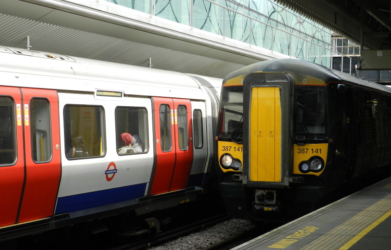 Underground and
                        National Rail train side by side