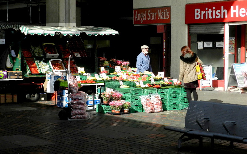 market stall in bright
                        sunshine and deep shadow