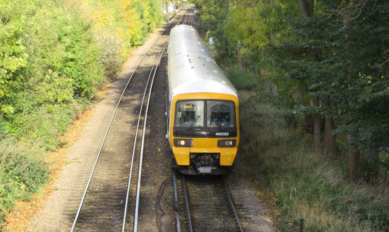 Train about to pass
                        under the footbridge