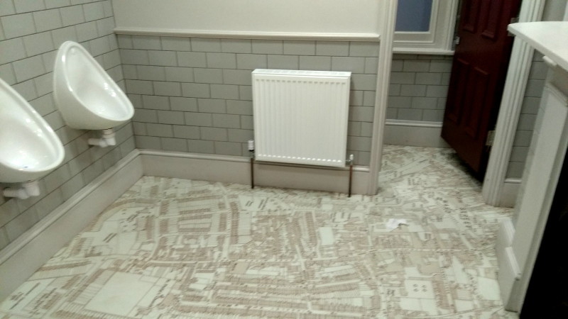 pristine toilets with a
                      map on the floor