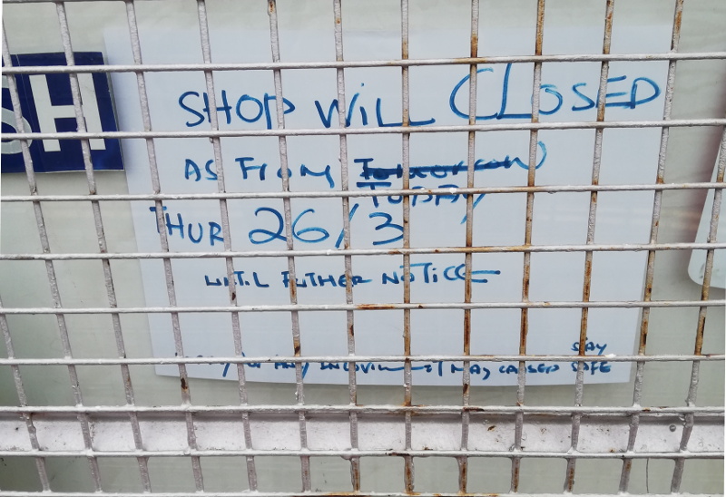 closure note on
                          corner shop door
