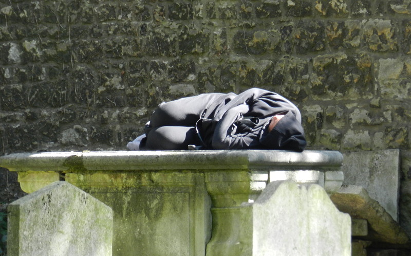 homeless man on
                                          gravestone